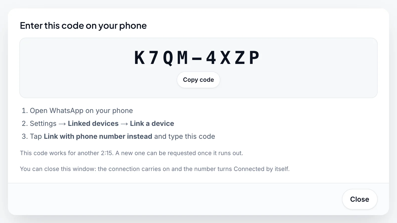 The Enter this code on your phone window with the code K7QM-4XZP, a Copy code button, the steps to link the phone and how long the code still works